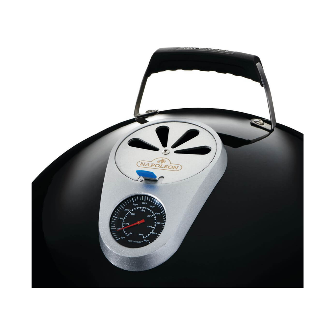 A close-up of a black Napolion kettle-style grill lid featuring a silver temperature gauge and vent cover with a black handle on a white background.